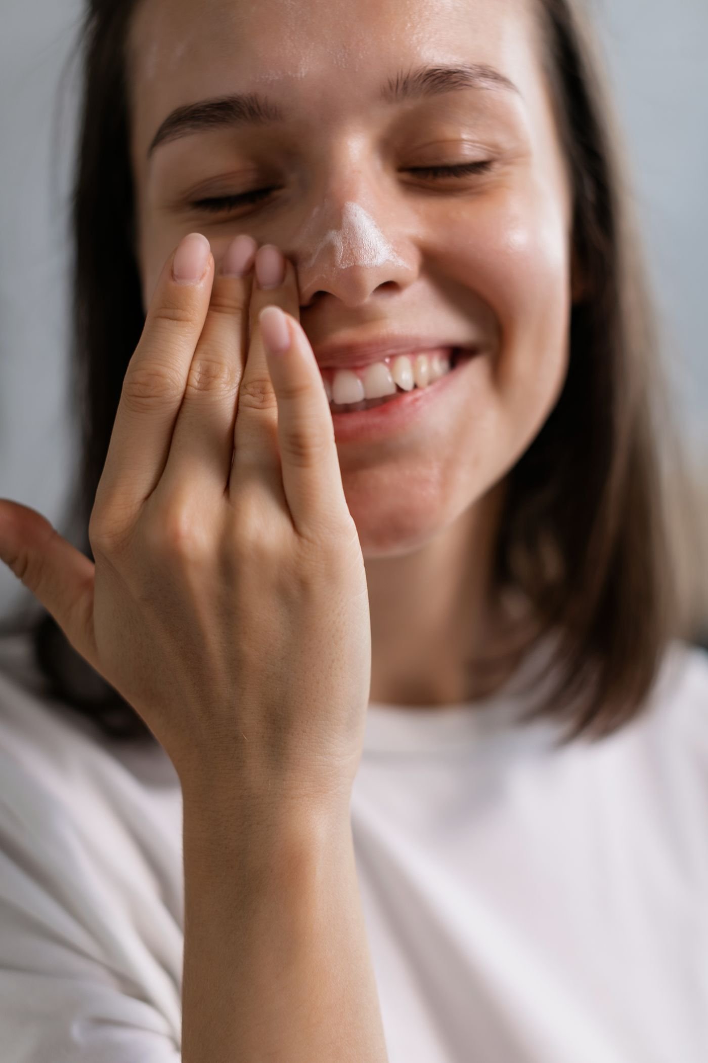 Person applying skincare to their cheek